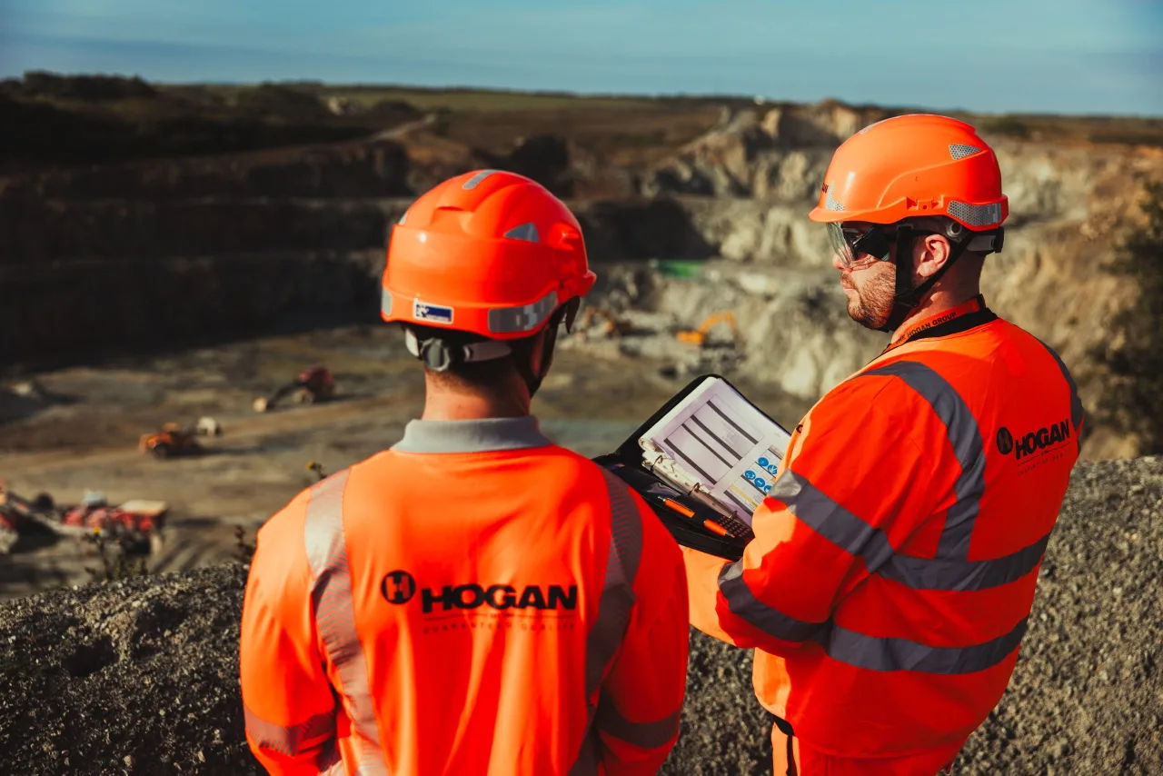 Two professionals in PPE quality controlling a quarry